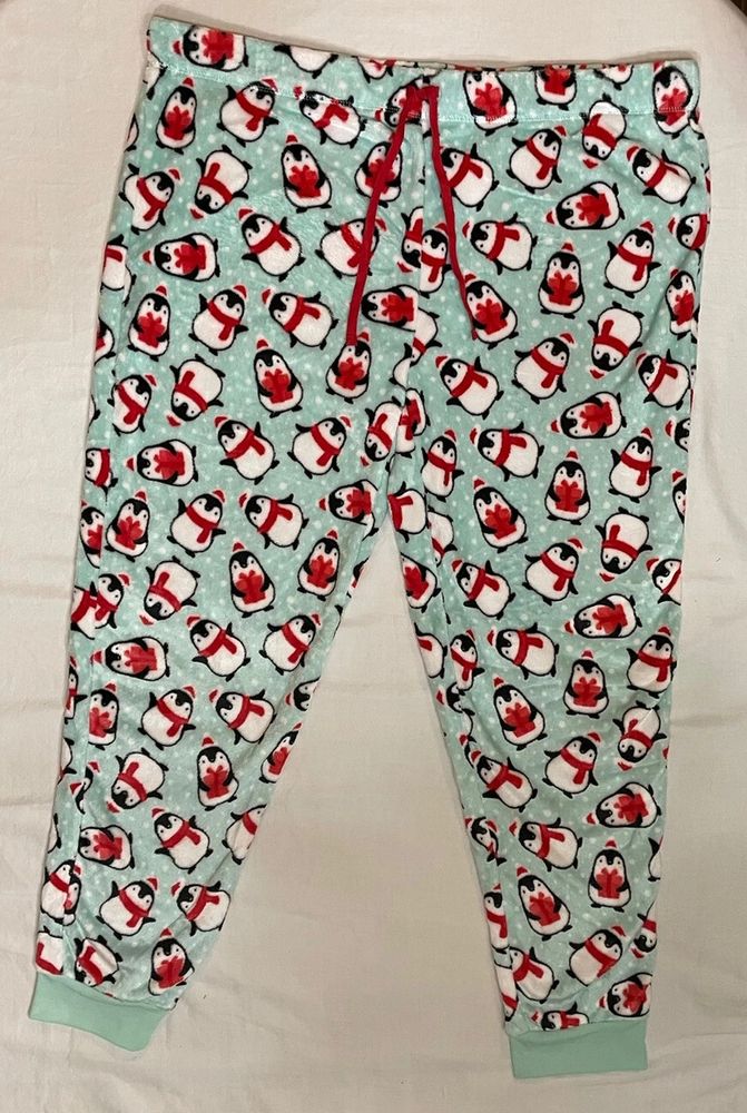 Pale green fuzzy fleece PJ pants with penguins all over them. Penguins in little red hats and scarves.