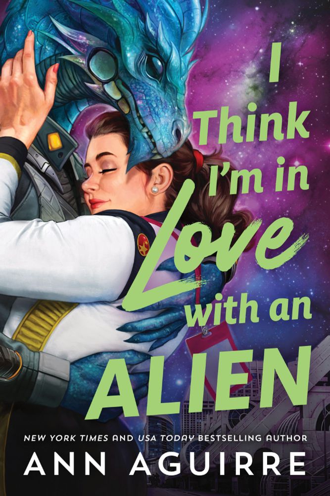 Pulp style romance cover with a purple pink galaxy background. A blue dragon inspired alien is in a classic romance clinch with a chubby human woman with a brunette ponytail. She is wearing a space fleet style costume. The font is graceful modern in lime green reading I Think I'm in Love with an Alien. NYT and USA Today bestselling author Ann Aguirre is in white font at the bottom.