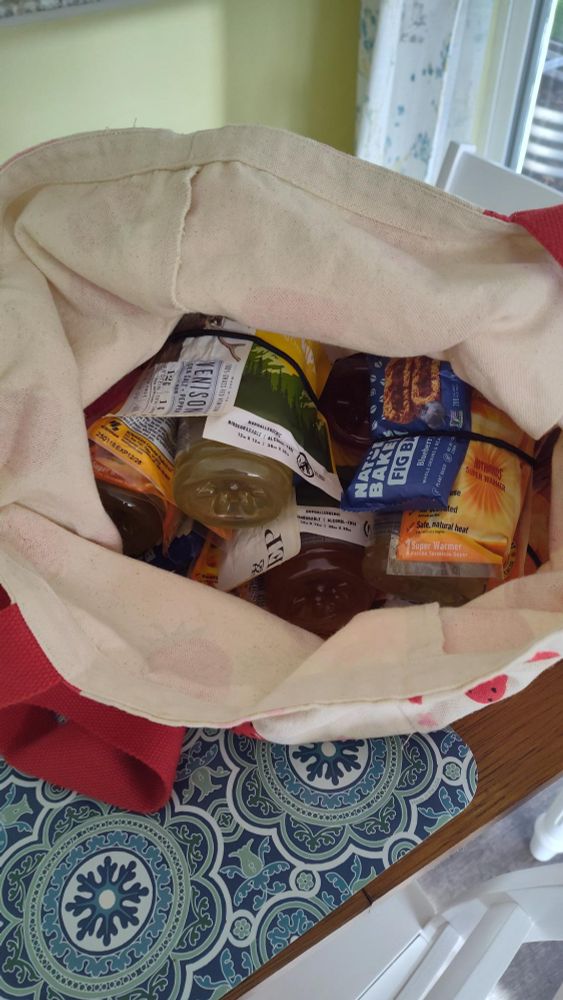 photo of a reusable shopping bag full of snack kits for use by unhoused neighbors

snack kit includes: a hand warmer, an epic meat bar, nature's bakery fig bars, a bar D shower wipe

The bag full of snack kits is sitting on a table