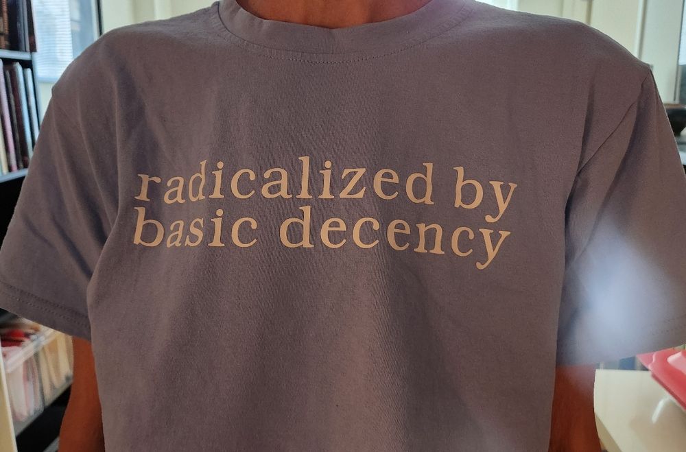 text on t-shirt reads "radicalized by basic decency"