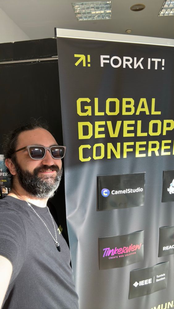 Yoann taking a selfie in front of a Fork it! Community rollup