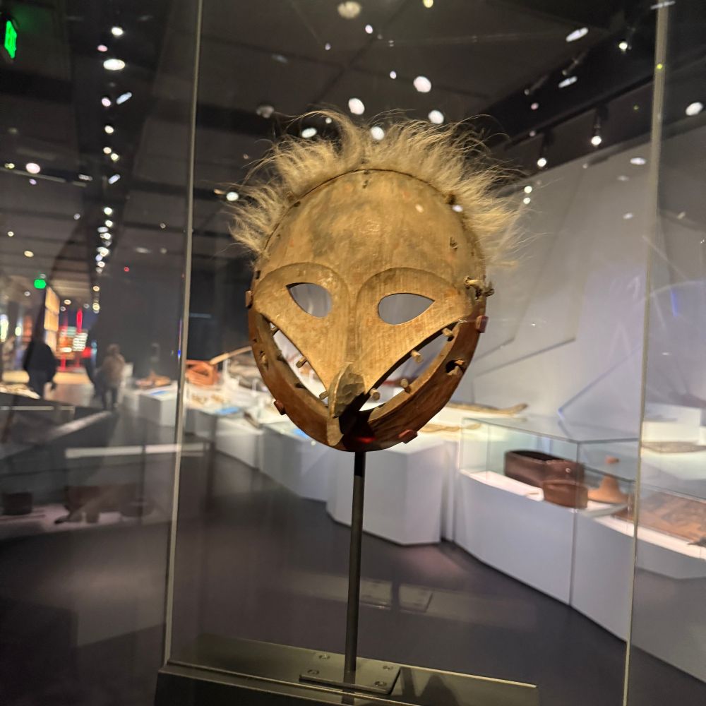 Another mask this one round with a beak nose and a wide large toothy grin.
