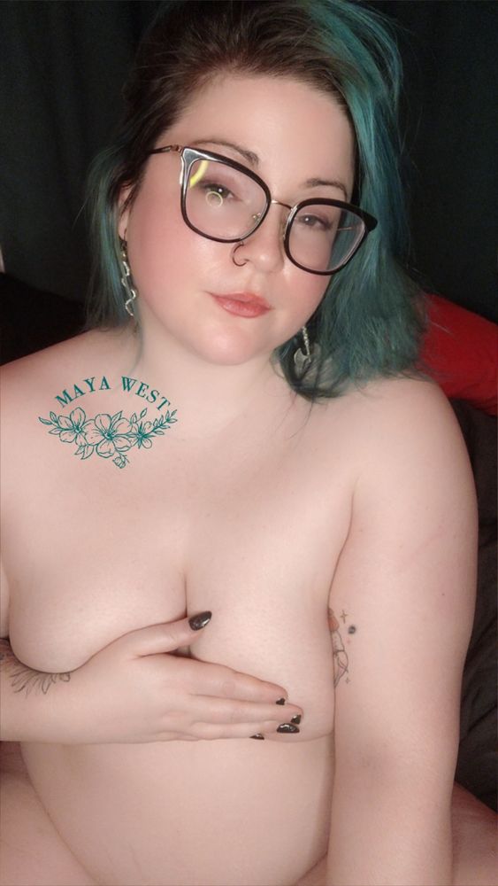 a pale, sleepy eyed femme in dark rimmed glasses. one hand is over her chest, covering her nipples. 
🧡🖤
#bbw #alt #nsfw 