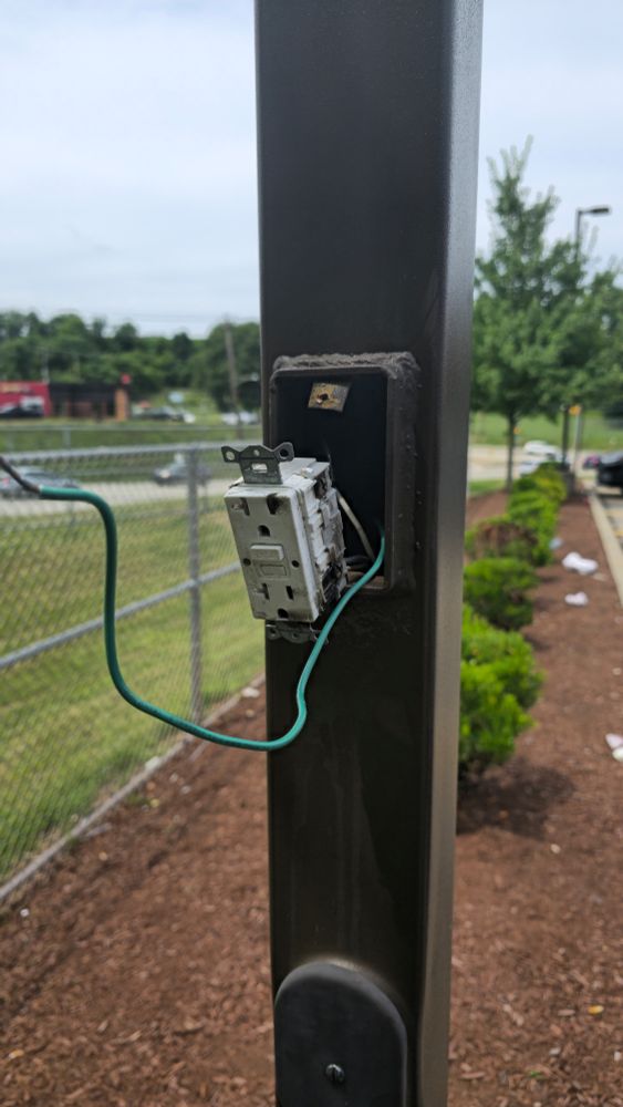 Stooped at local gas station. Parking lot light looked to have a socket. It's looks burnt and a green wire is exposed.  Assuming the green is ground. 