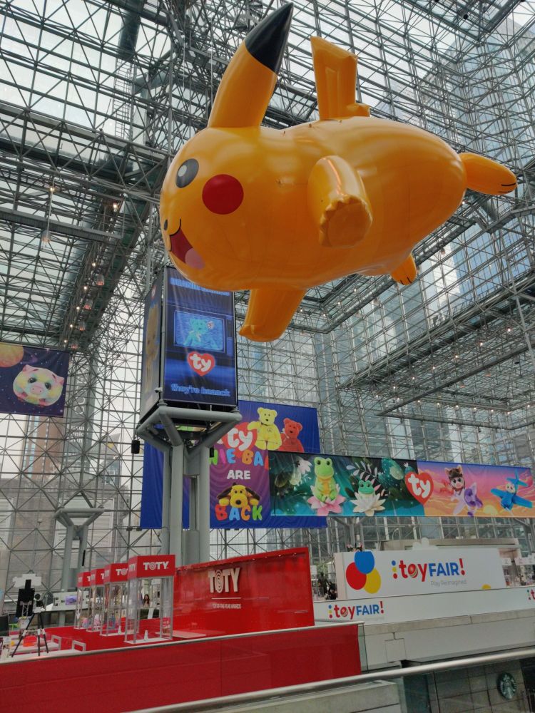 Large inflatable Pikachu hans from the ceiling of a glass building