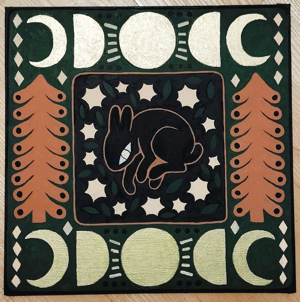 Square painting made with posca markers. The colors are a mix of olive green, reddish brown, black, cream and gold. There is black bunny in the middle, surrounded by stars and leaves. On both sides there are brown spruce trees and on top and bottom there are golden moon phases. The bunny also has golden eyes.