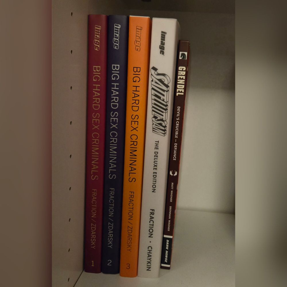 Shelf of books including Big Hard Sex Criminals, Satellite Sam, and Grendel