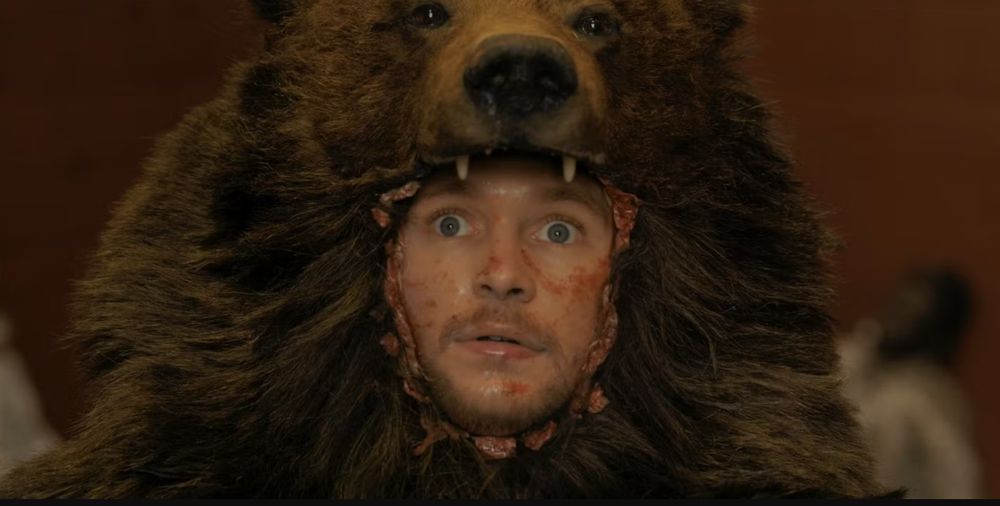 Jack Reynor in film Midsommar wears a bearkskin and a frightened expression. 