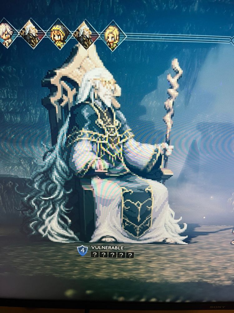 It’s a boss in octopath traveler. It’s pixel art of a seated wizard guy with long gray hair and he’s holding a staff