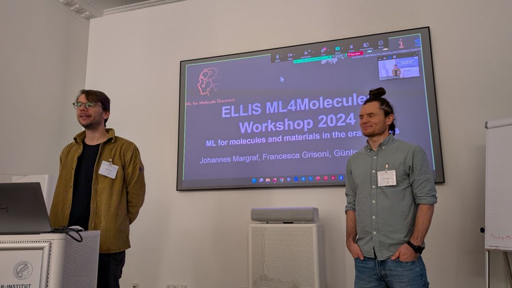 Photograph of Johannes Margraph and Günter Klambauer introducing the ELLIS ML4Molecules Workshop 2024 in Berlin at the Fritz-Haber Institute in Dahlem.
