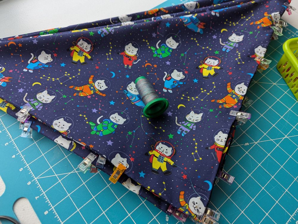 Stack of space cat bandanas ready to be sewn