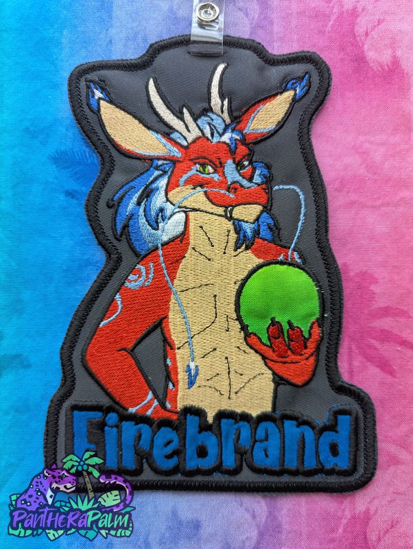 Embroidered artwork of red dragon holding green orb with name Firebrand