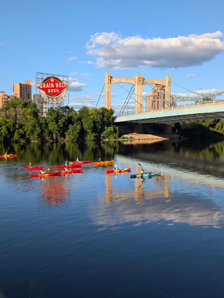 Canoes on the Mississippi River under the Grain Belt Beer sign near the Hennepin Street bridge in Minneapolis. 