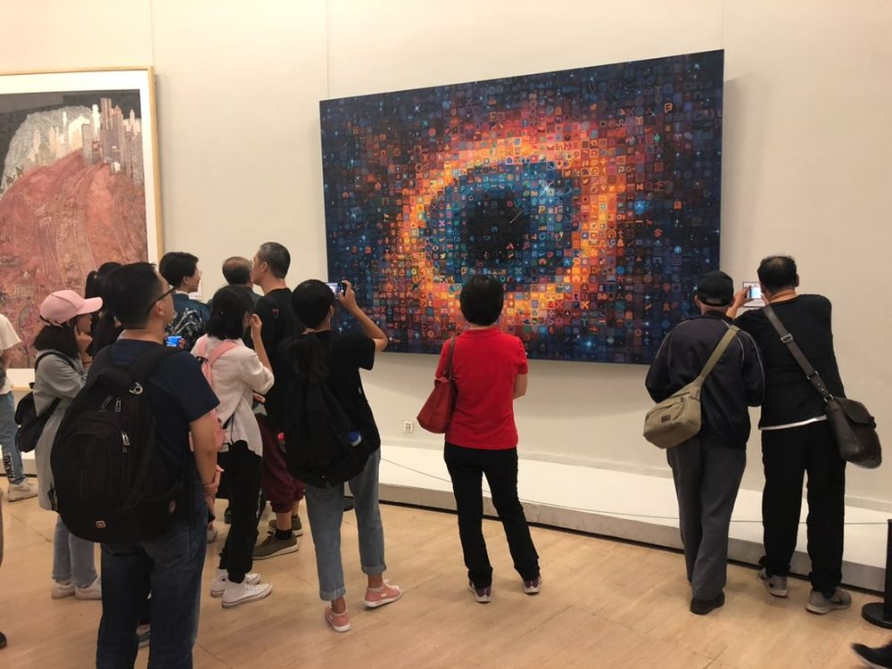 People viewing painting of "Eye in the Sky" by Tao Hong exhibited at the National Art Museum in Beijing, China in 2019.