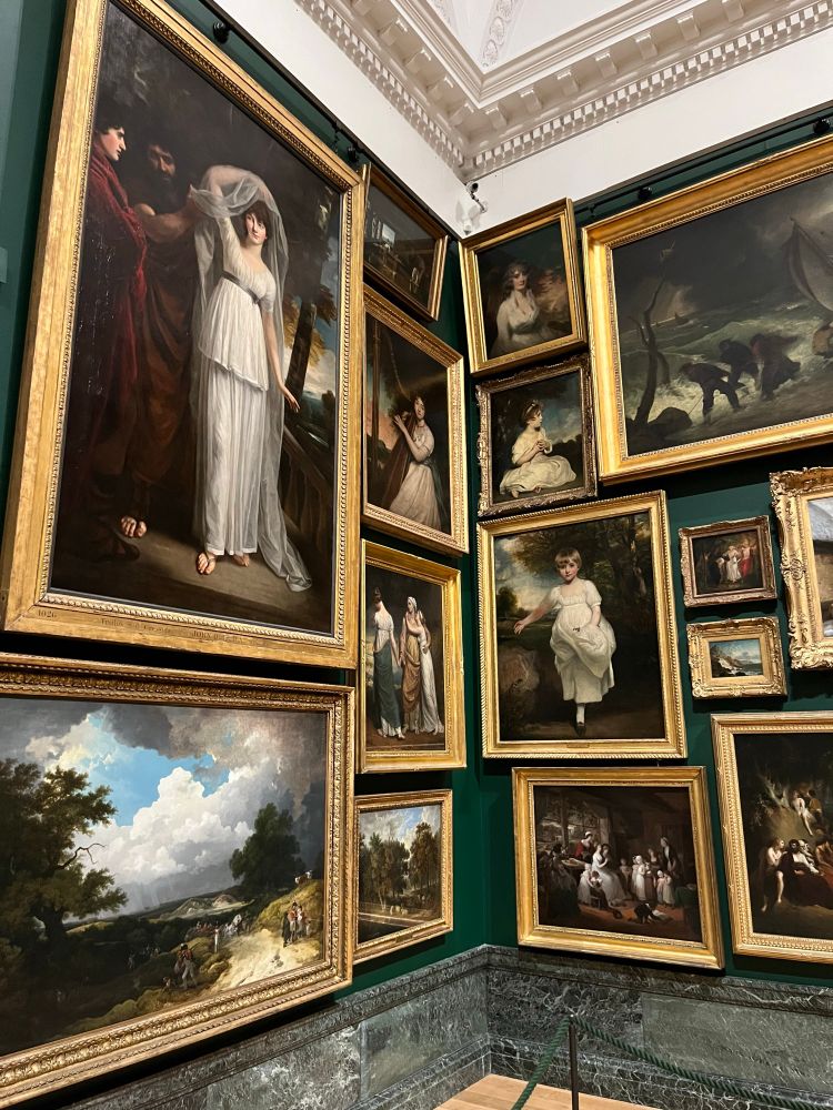 Gallery wall covered with golden frame portraits