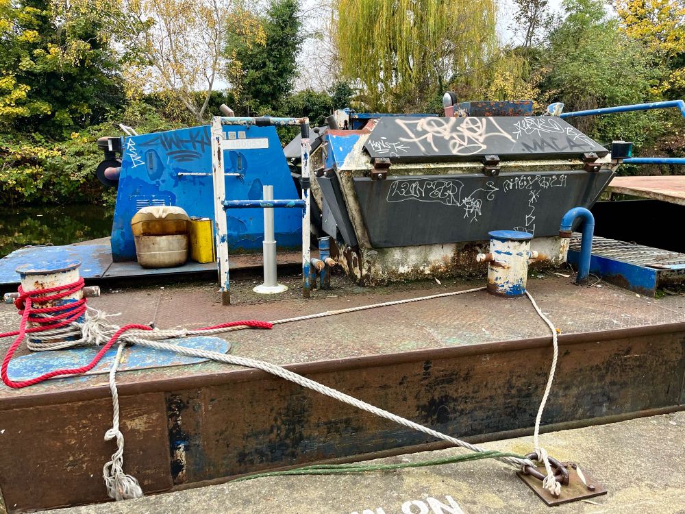 Canal barge motor house with hinged panels and grated floor and handrail