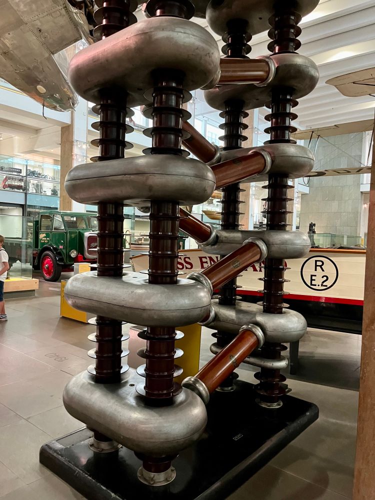 In the struggle to 'split the
atom', this machine accelerated
protons using high voltages.
Scientists smashed them into atomic nuclei and analysed the resulting fragments to determine atomic structure.
This technique, devised by John Cockcroft and Ernest Walton, at the Cavendish Laboratory in Cambridge in 1932, revealed new particles from within the nucleus.
As understanding of atomic structure and disintegration grew during the 1930s, it led directly to ideas for the atomic bomb and for atomic power. During the Second World War scientists used this machine to investigate the properties of
uranium and plutonium as acontribution to the
Manhattan Project which manufactured the first atomic bombs.
Source: The Cavendish Laboratory, Cambridge
Inv. 1982-1318

Text from museum display