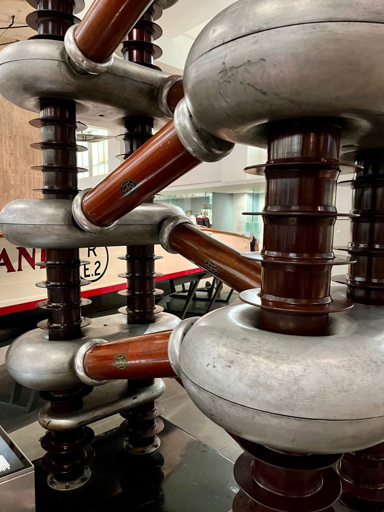 In the struggle to 'split the
atom', this machine accelerated
protons using high voltages.
Scientists smashed them into atomic nuclei and analysed the resulting fragments to determine atomic structure.
This technique, devised by John Cockcroft and Ernest Walton, at the Cavendish Laboratory in Cambridge in 1932, revealed new particles from within the nucleus.
As understanding of atomic structure and disintegration grew during the 1930s, it led directly to ideas for the atomic bomb and for atomic power. During the Second World War scientists used this machine to investigate the properties of
uranium and plutonium as acontribution to the
Manhattan Project which manufactured the first atomic bombs.
Source: The Cavendish Laboratory, Cambridge
Inv. 1982-1318

Text from museum display