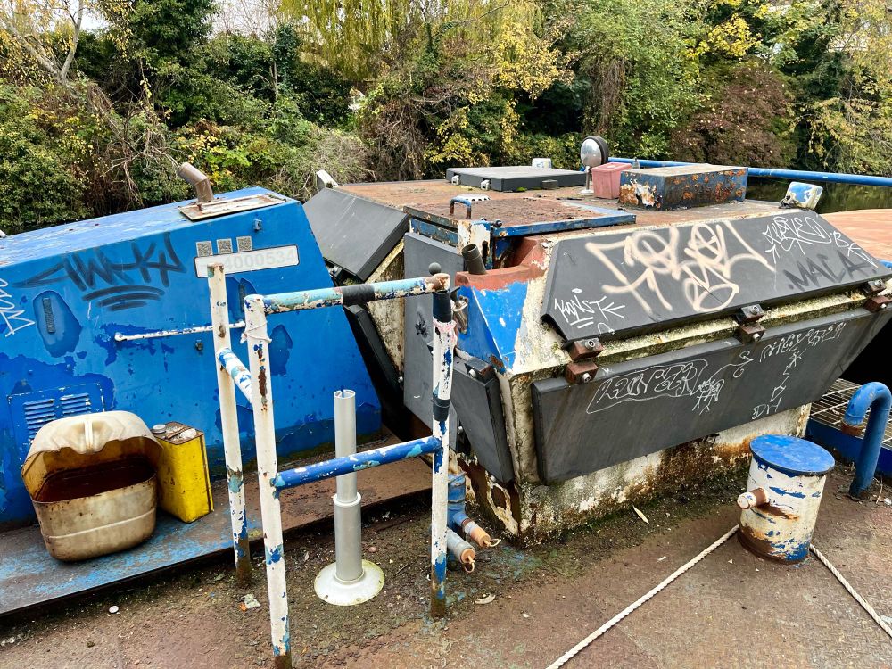 Canal barge motor house with hinged panels and grated floor and handrail