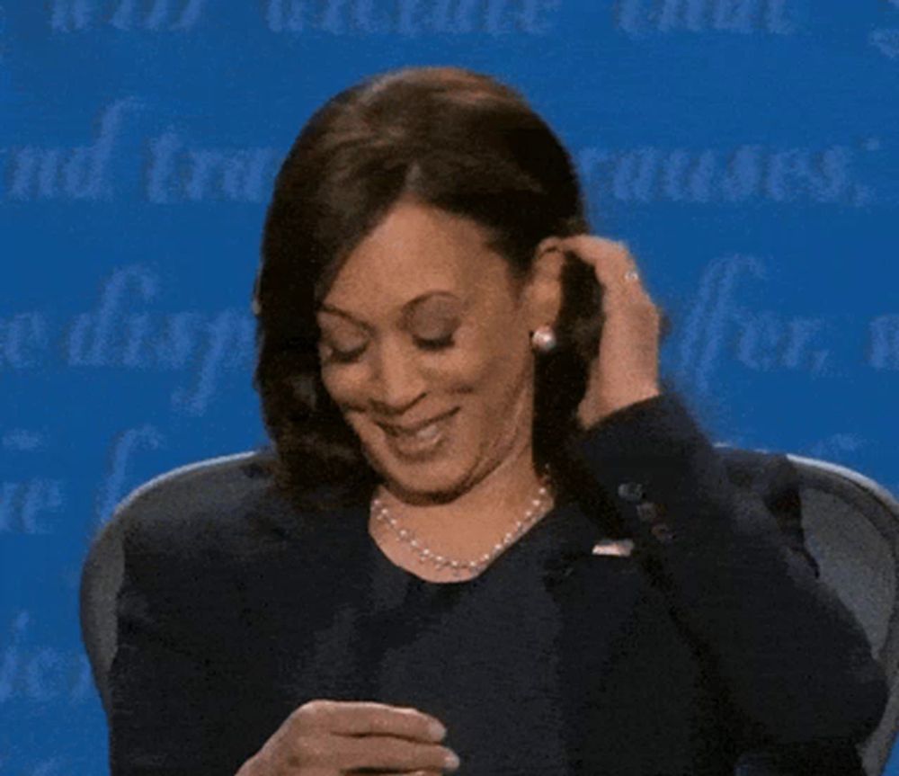 a woman is sitting in front of a blue wall that says causes