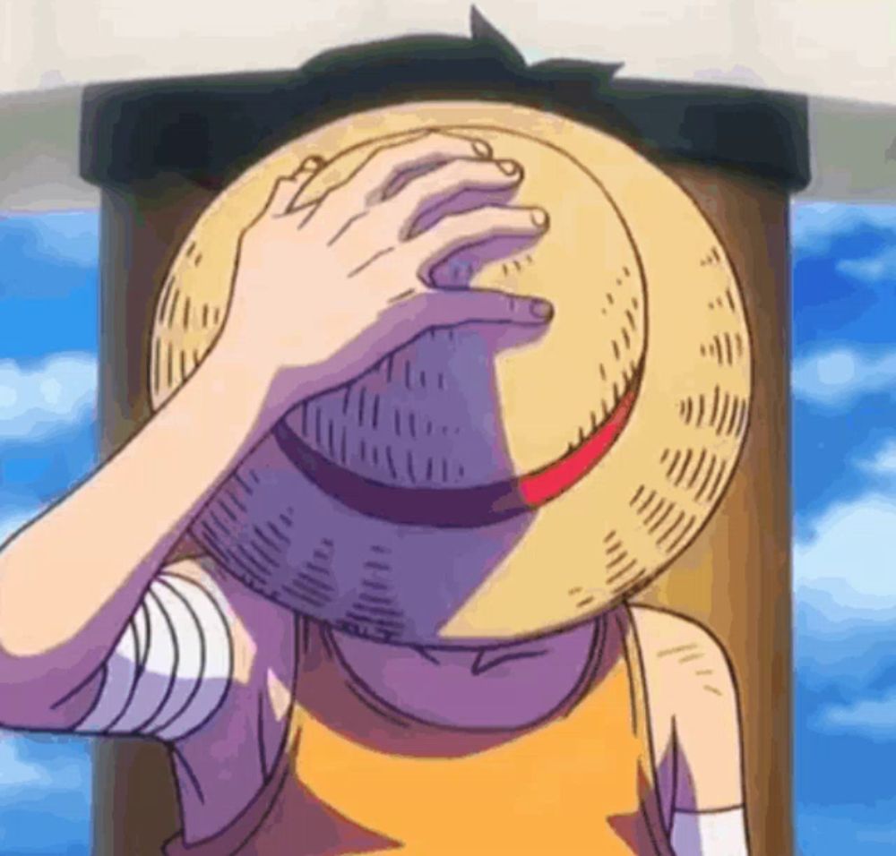 luffy from one piece is covering his face with his hat