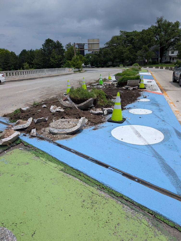 A destroyed neighborhood mural and planters 