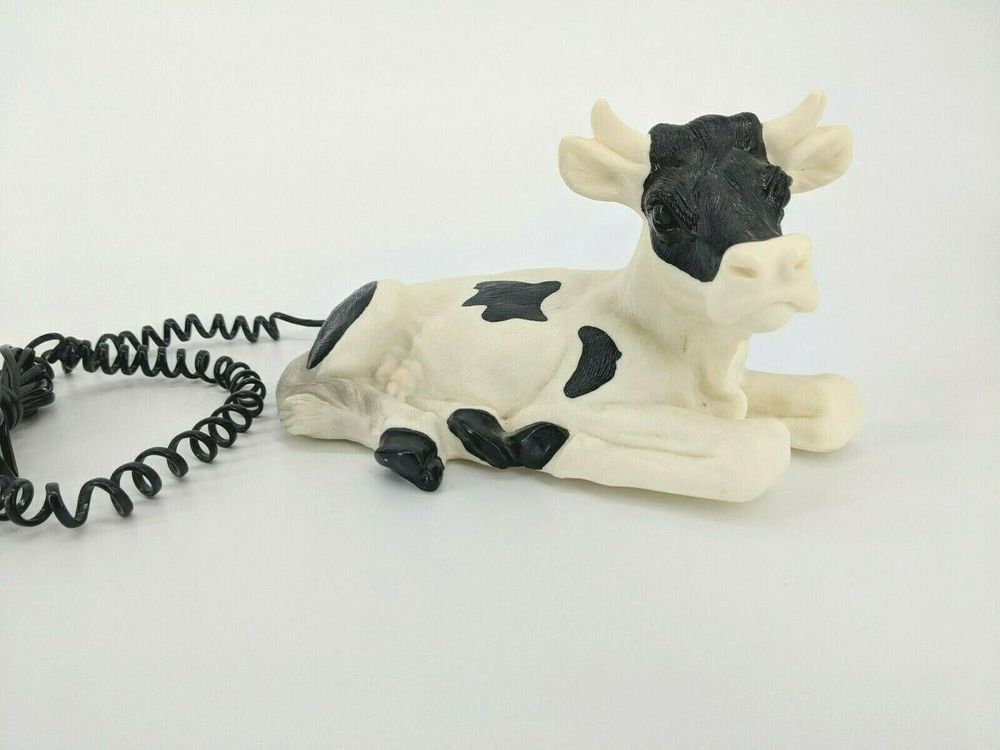 A phone shaped like a black and white spotted cow