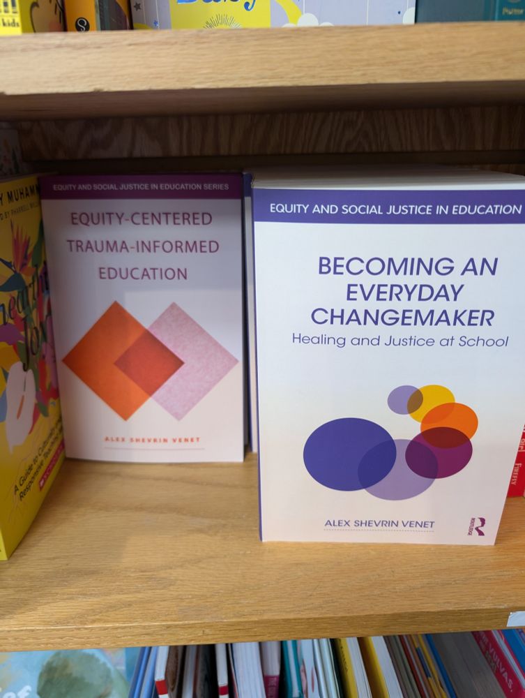 two books on a bookstore shelf, both by Alex Shevrin Venet: Equity-Centered Trauma-Informed Education and Becoming an Everyday Changemaker 