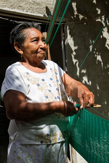 Woman weaving a hammock