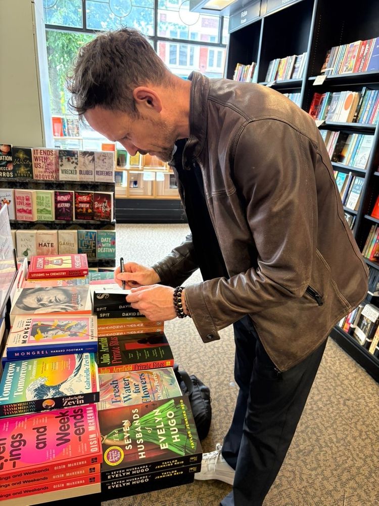 David signing copies of his book 