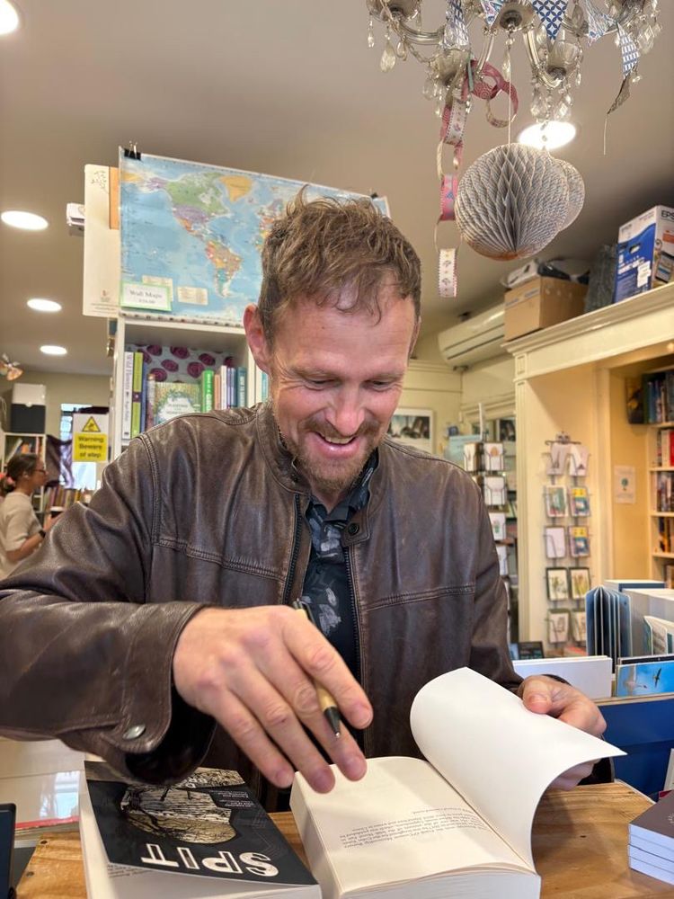 David signing copies of his book 