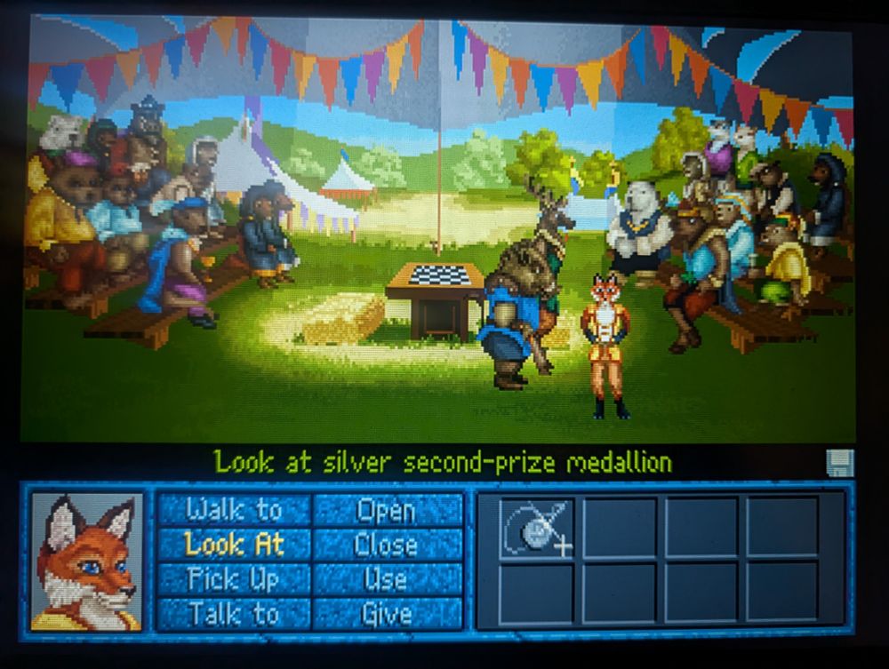 A screenshot of "Inherit the Earth: Quest for the Orb". The protagonist, a fox, stands under a festive tent by a game board, and in front of a dozen or so anthropomorphic animal characters.