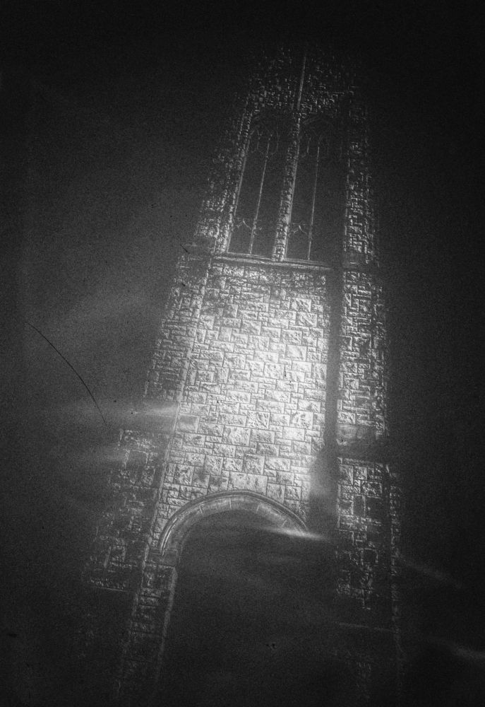 The image is a black and white photograph of the Tower of Memories bell tower, captured by Hellbound Black (Ry Summers) at the Memorial Park Funeral Home & Cemetery in Edmond, Oklahoma.