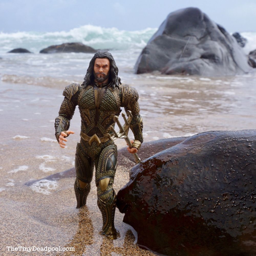Aquaman emerges from the sea carrying his trident, knowing he’s already running late for lunch with Batman