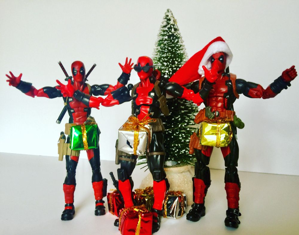 Three Deadpool’s stand in front of a Christmas tree with their hands up while Christmas packages remain in front of their waists like the SNL song “dick in a box”.
#deadpool #actionfigure #toyphotography #photography 