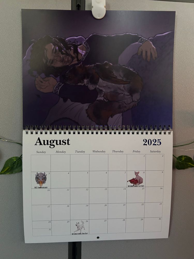 Image shows a calendar displaying the month of august, with Gale Dekarios from Baldur’s Gate 3 cuddling his Tressym, Tara. 