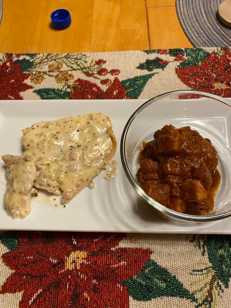 Fish with a cream sauce and a side of vegetable vindaloo 