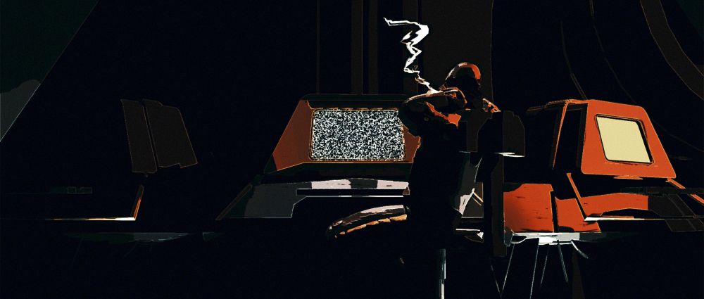 man smokes in front of computer console that is broken. 