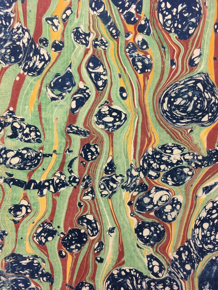 Blue & white splotches against a background of flowing green, red, and yellow. The effect is like rocks in a psychedelic stream 