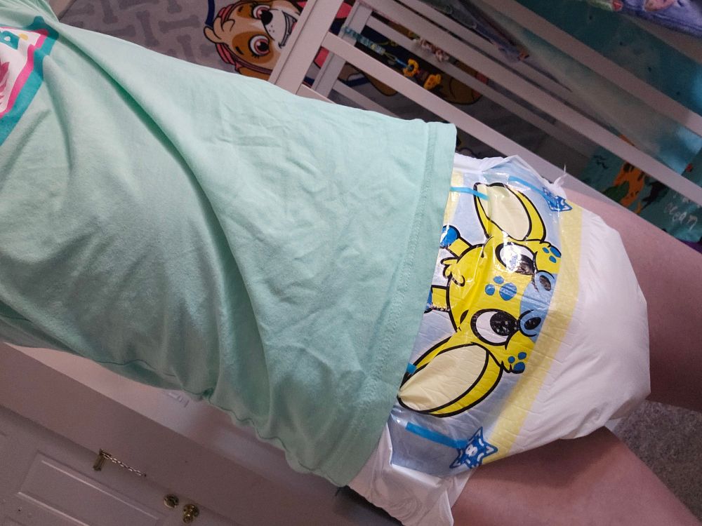 Me in a light green shirt and a giraffe peekabu diaper 