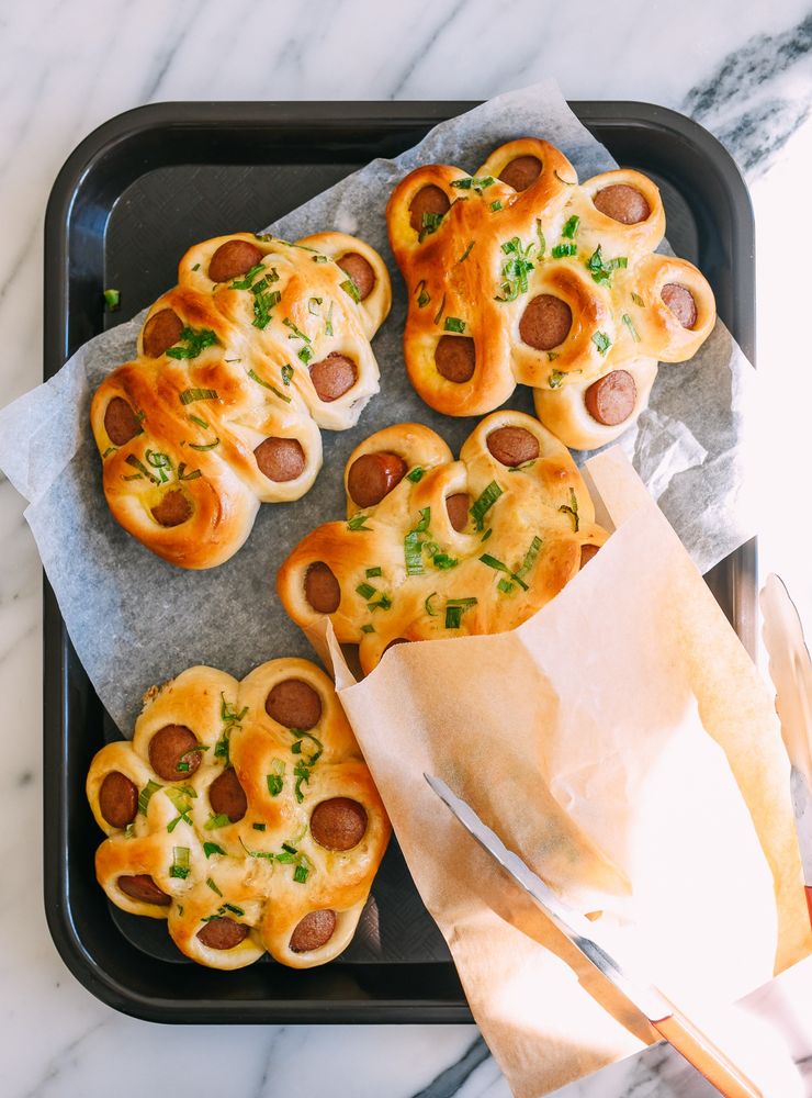 Hot dogs baked into buns with chives on top