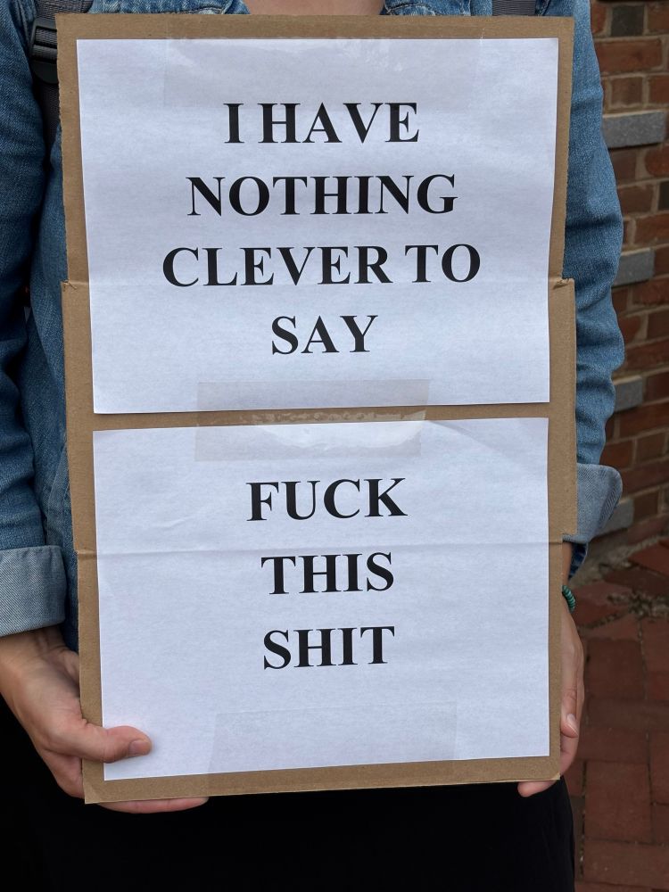 Protest sign reading “I have nothing clever to say. Fuck this shit.”