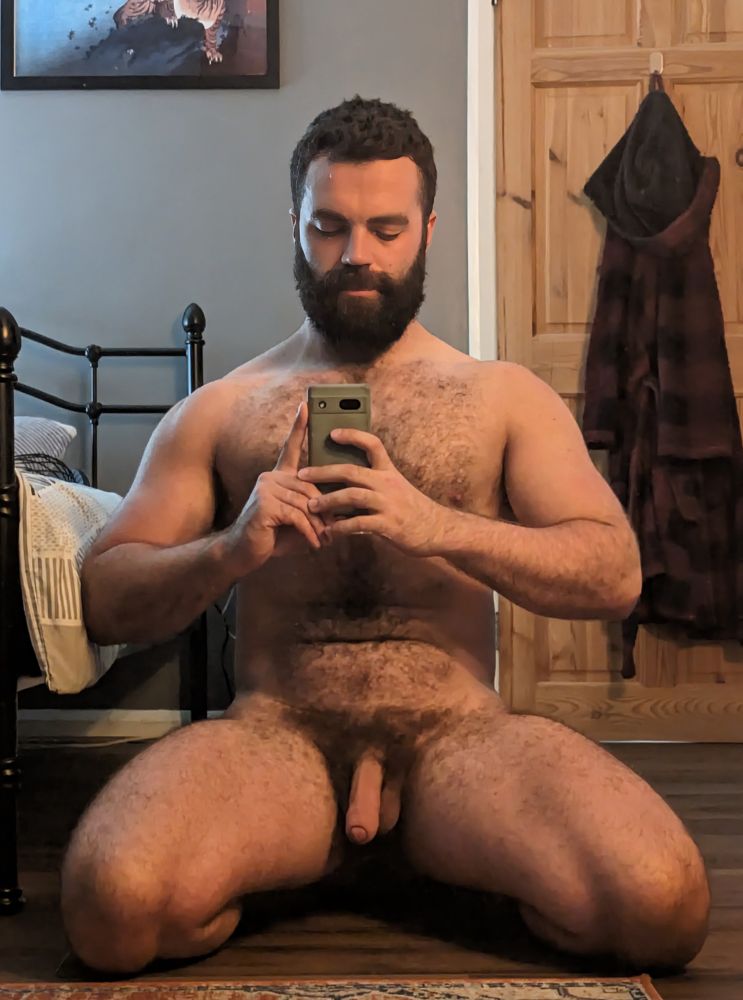 A selfie of me on my knees, naked in the bedroom. 