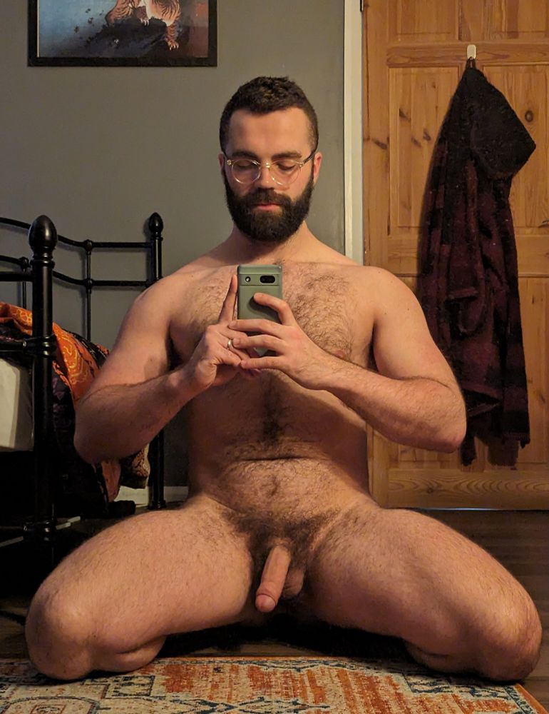 A selfie of me on my knees, naked, in the bedroom.