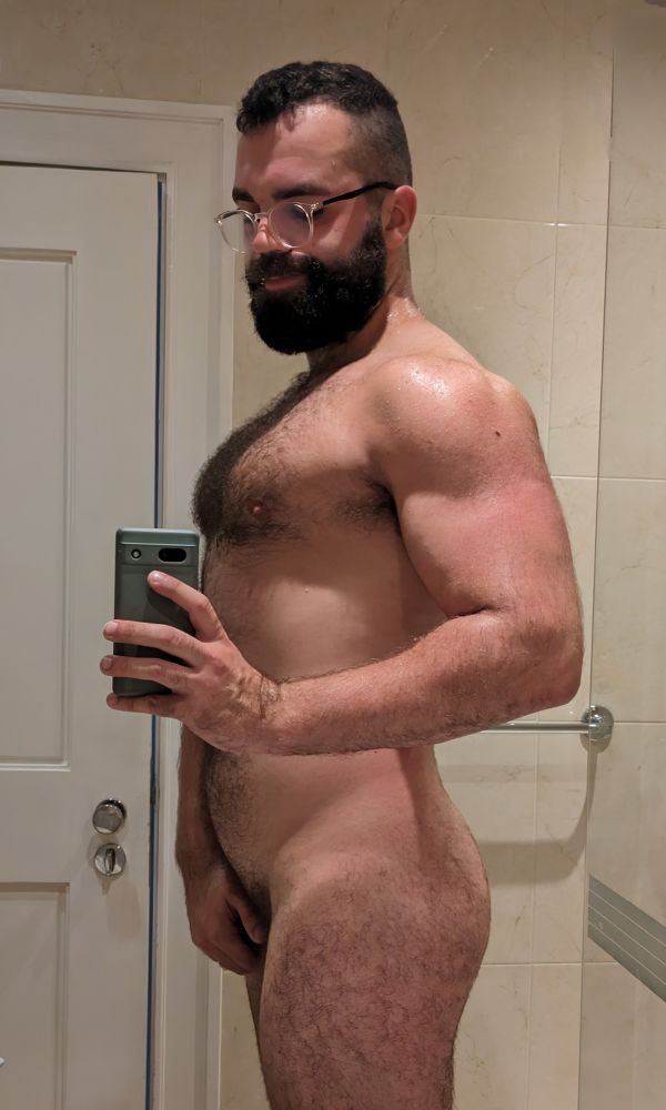 A side shot of me, naked in a hotel bathroom. I'm covering my crotch. 