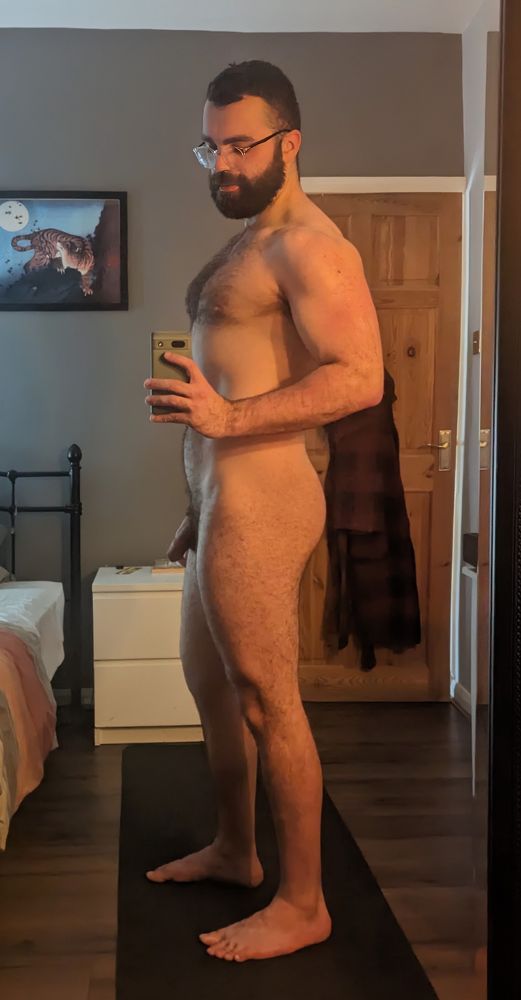 A selfie of me, standing in the bedroom, naked. 