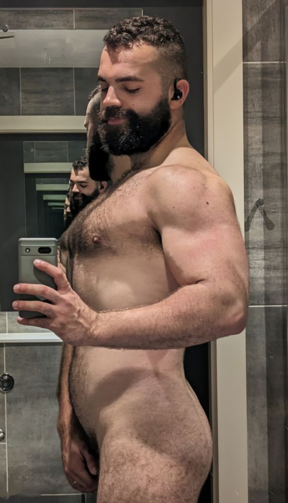 A selfie of me standing in a hotel bathroom, naked and shot from the side. 