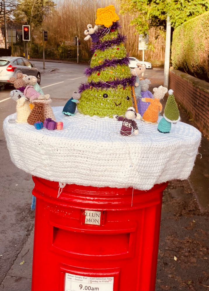 Postbox with Christmas yarn bomb and festive mice