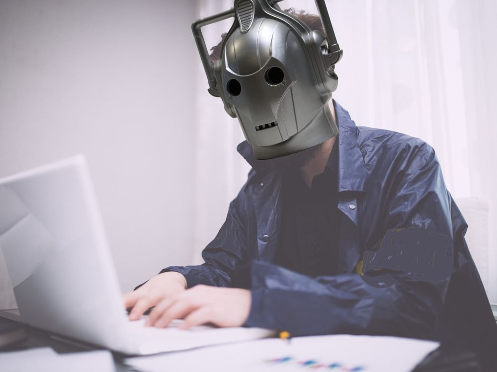 Cyberman typing on a laptop (definitely not a selfie)