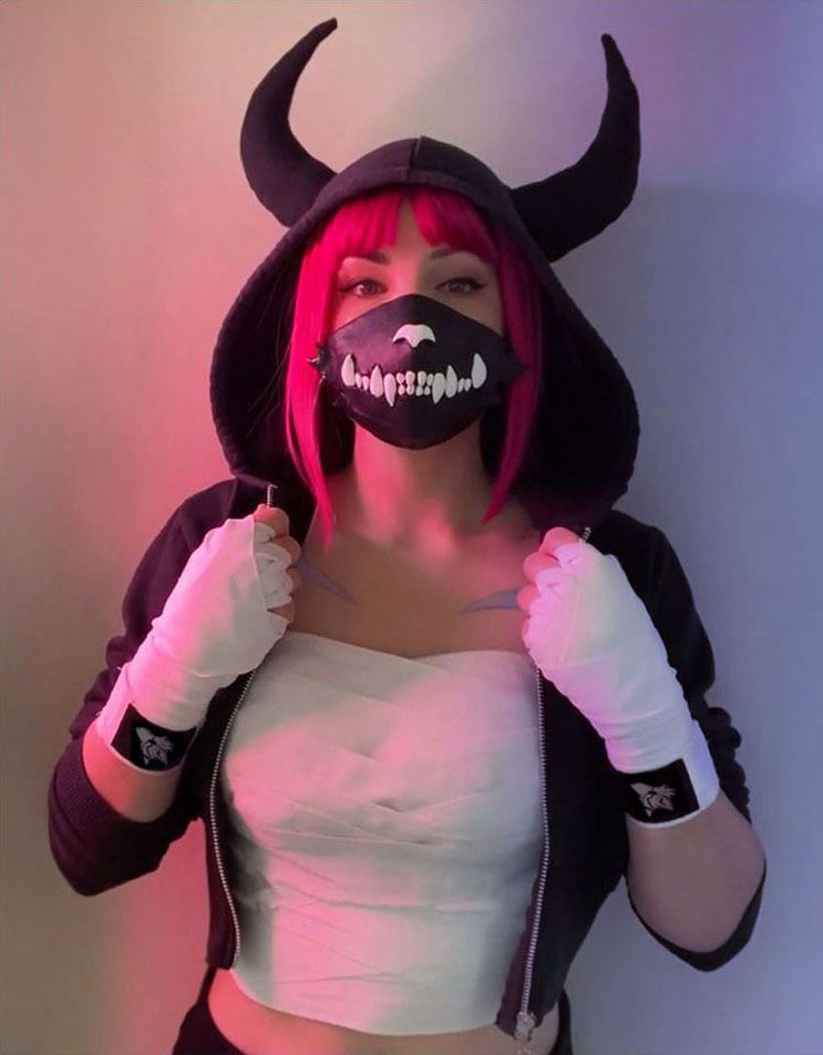 Fighter with pink hair wearing a black horned hoodie